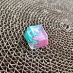 Vibrant handcrafted graffiti resin ESC keycap from different angles, featuring abstract splatter art and bold contrasting colors. A unique artistic angle.
