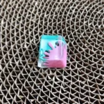 A close-up of a vibrant handcrafted graffiti resin keycap, showcasing its unique splatter art design and bold, contrasting colors, optimized for ESC Key.