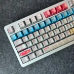 Close-up of the iconic RX-78-2 Gundam metallic-finish keycap set, showcasing its premium mecha aesthetic from multiple angles.