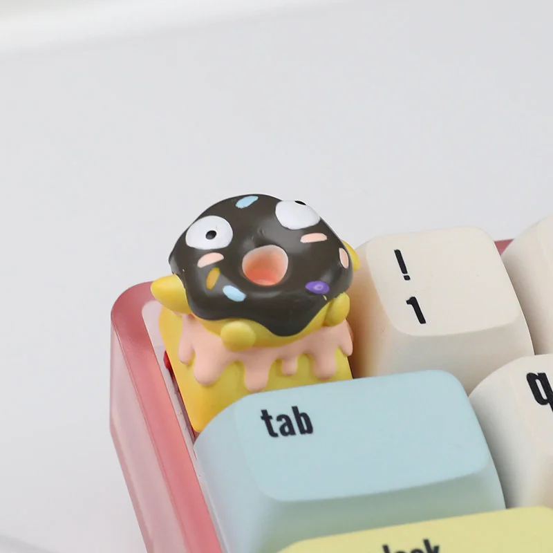 A whimsical handcrafted 3D chocolate donut keycap, showcasing its realistic texture and charming sprinkles from a delightful side angle.