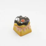 Delightful close-up showcasing the handcrafted 3D chocolate donut keycap's realistic texture, vibrant sprinkles, and playful charm from a unique angles.