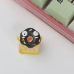 A handcrafted 3D chocolate donut keycap, showcasing its whimsical charm and realistic textured details from a unique angle.