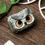 Close-up of the handcrafted resin owl artisan keycap, showcasing its enchanting forest design and unique artistic details from a captivating side preview.