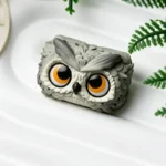 An artistic angle of a handcrafted resin owl artisan keycap, highlighting its unique details and the enchanting forest mystique of its design.