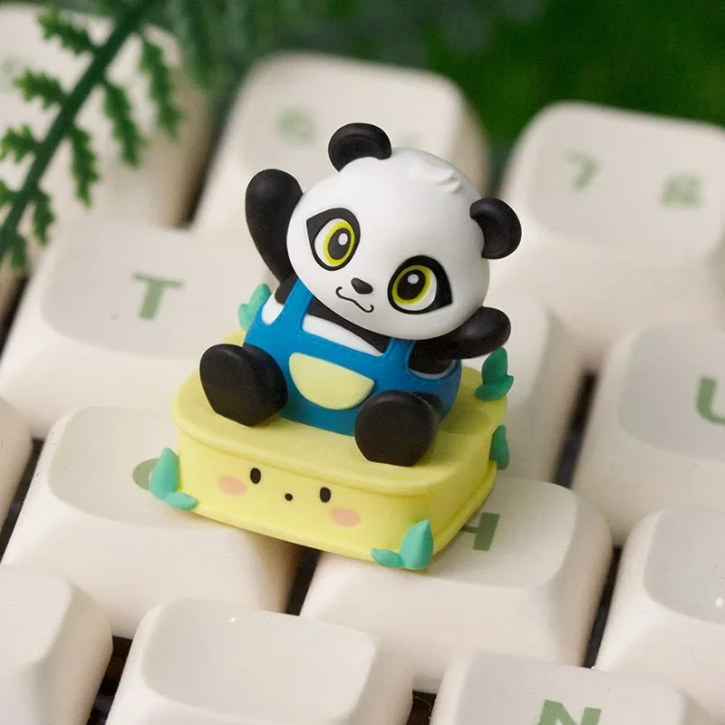 Close-up of a handcrafted resin panda keycap for the ESC key, showcasing its adorable details and whimsical pose from multiple artistic angles.