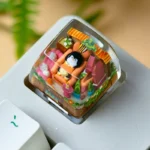 Detailed view of a whimsical handcrafted resin penguin keycap, showcasing its charming design, glossy finish, and vibrant arctic colors. A unique design.