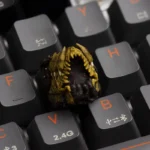Close-up of a handcrafted resin Cosmic Dread Cthulhu ESC keycap from multiple angles, showcasing its intricate, dark Lovecraftian horror details.