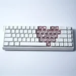 Romantic Heart Butterfly Supplement Keycap Set, translucent and shimmering, glowing with backlight on a PC keyboard, shown from various artistic angles.