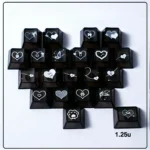 A close-up of translucent black heart butterfly Supplement Keycap Set glowing with soft backlight, featuring a delicate artistic design for mechanical keyboards.
