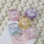 Detailed view of an exclusive Hello Kitty Star Bottle artisan resin ESC keycap, showcasing its dreamy pastel colors and sparkling star design from various angle.