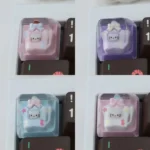 A dreamy pastel Hello Kitty artisan resin keycap showcasing Hello Kitty in a sparkling star bottle, an exclusive ESC keycap.