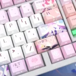 Honkai Star Rail Cyrene PBT side-lit keycaps set displayed from multiple angles, highlighting premium translucent legends and vibrant RGB illumination.