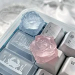 Multiple angles of the Ethereal Ice Rose Translucent Keycap, showcasing its delicate frosted glow and intricate rose design for a mystical keyboard accent.