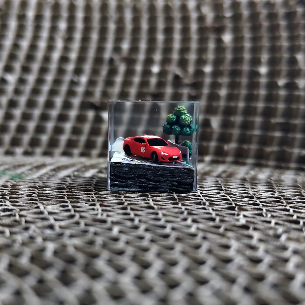 Initial D AE86 drifting artisan JDM resin keycap. It details the iconic AE86 in a vibrant, dynamic street racing pose.