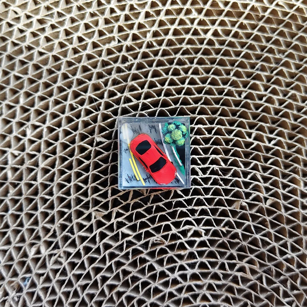 Close-up of the Initial D AE86 drifting artisan JDM resin keycap, showcasing its intricate details and dynamic pose from a unique angle, an artistic setup.