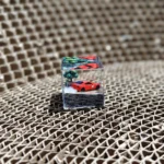 Close-up of the Initial D AE86 drifting artisan JDM resin keycap, showcasing the iconic miniature car in a vibrant, dynamic drifting pose with intricated design.