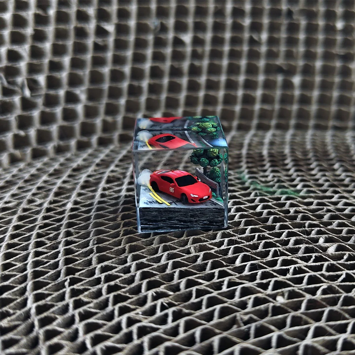 Artistic Initial D Keycap featuring the iconic AE86 drifting artisan. Detailed miniature AE86 in a dynamic JDM street racing pose.