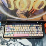 Vibrant JoJo's Bizarre Adventure PBT side-lit keycaps set, showcasing iconic characters and bold colors from multiple angles. See the unique illumination design.