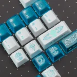A collection of Eternal Spear R3 Keycaps Set from multiple angles, showcasing their pristine, mirror-polished, jade-like finish and unique setup.