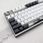 An angled shot of the Serene Lotus PBT Dye-sub Keycap Set, showcasing the tranquil PBT keycaps and their elegant, subtle lotus flower artistic design.