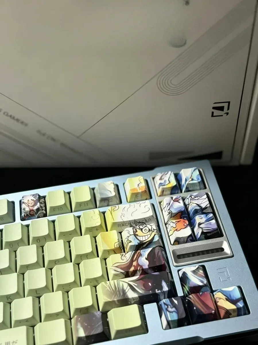 Playful Luffy PBT keycaps set. Vibrant One Piece character art, unique side-engraved, light-transmitting legends. Durable PBT material details.