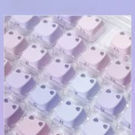 Whimsical Luminous Cat Keycap Set, showcasing a glowing feline among serene water lilies. Its artistic PBT design reveals unique details and soft hues.