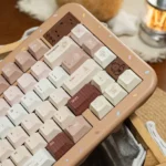 Caramel Maillard PBT dye-sub keycap set, featuring rich caramel keys with creamy legends. Durable Cherry profile displayed from multiple angle.