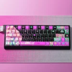 Close-up of exclusive Marin Kitagawa PBT+PC keycaps set, showcasing vibrant anime art, a playful aesthetic, and transparent PC accents for backlighting.