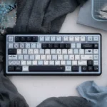Mercury Blue & Pink Cherry Keycap Set, highlighting its durable PBT and artistic cosmic design with ethereal blues and pinks.