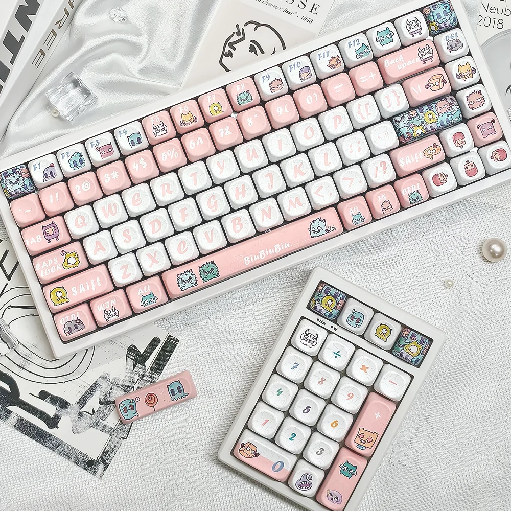 Detailed views of playful Strange Beast MOA PBT keycaps, highlighting their whimsical monster art and ergonomic MOA profile for comfortable.