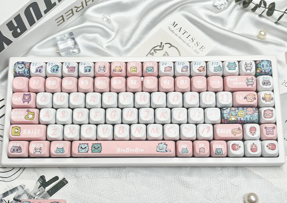 A full set of playful Strange Beast MOA PBT keycaps featuring whimsical monster art, showcasing their ergonomic MOA profile for comfortable typing.