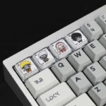 Close-up view of the exquisite handcrafted Naruto Chewing Resin Keycaps, showcasing vibrant, detailed anime characters in playful poses from multple angles.