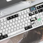 NieR Automata Keycaps YoRHa 2B Dye-Sub PBT set showcased from multiple artistic angles, emphasizing the iconic dystopian sci-fi aesthetic and monochrome design.