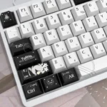 NieR Automata Keycaps YoRHa 2B Dye-Sub PBT set showcased from various artistic angles, emphasizing its iconic dystopian sci-fi aesthetic, monochrome setup.