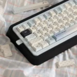 Premium PBT Sea Salt keycaps set, a 145-key boxed set, showcasing tranquil uppercase characters with a subtle speckled dot pattern. Durable dye-sub design.
