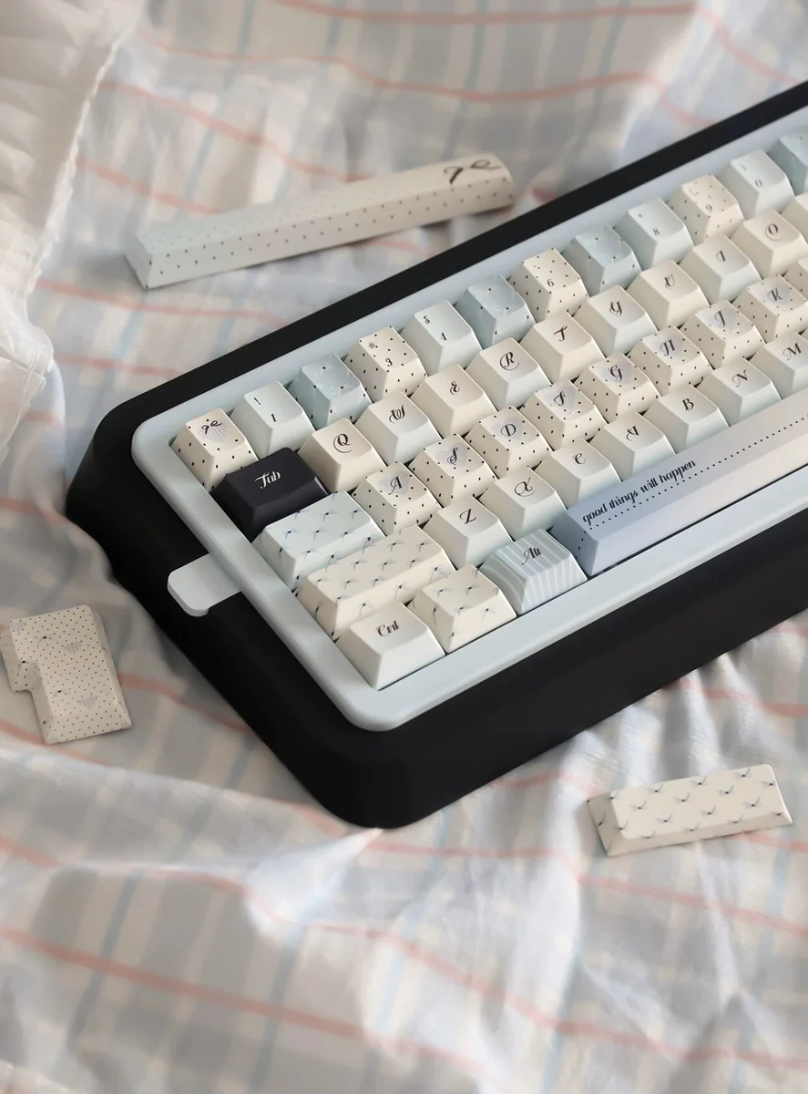 Premium PBT Sea Salt keycaps set, a 145-key boxed set, showcasing tranquil uppercase characters with a subtle speckled dot pattern. Durable dye-sub design.
