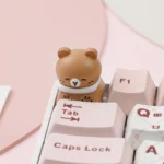 Various angles of charming handcrafted pet cafe keycaps, showcasing whimsical animal friends enjoying a pastel-themed coffee shop scene.