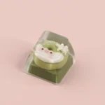 Adorable handcrafted piggy donut artisan ESC keycap, uniquely styled in a sweet matcha green, for a playful dessert-themed keyboard.