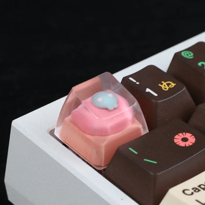 A close-up side view of the whimsical handcrafted pink cat keycap, revealing its adorable luminous resin cat head and charming details.