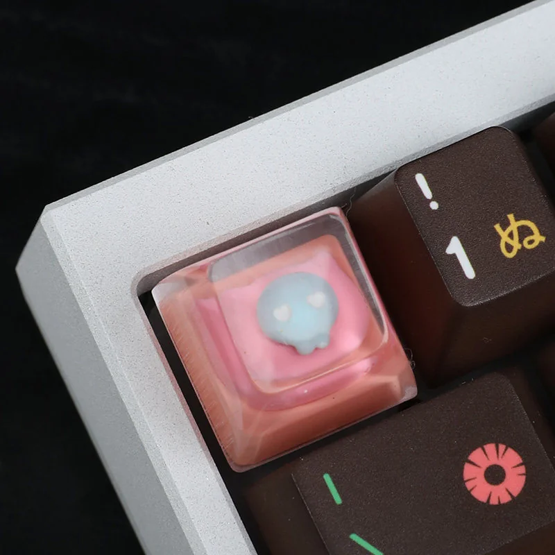 Whimsical handcrafted resin pink cat keycap featuring an adorable, luminous pink cat head design, adding charm to any keyboard.