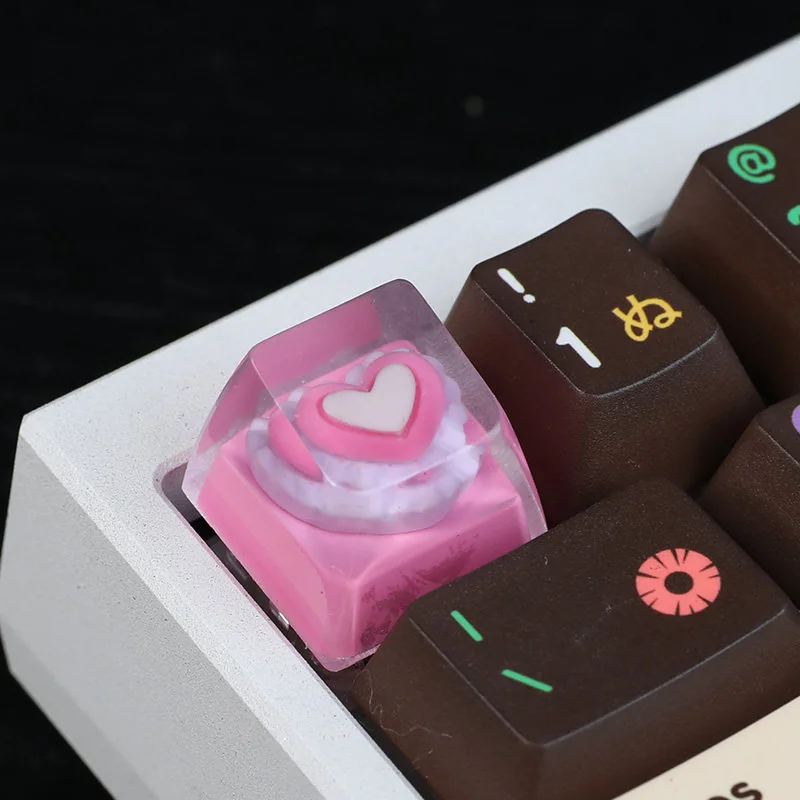 A vibrant close-up of the handcrafted pink heart keycap, revealing its smooth, glossy resin and the charming embedded pink heart, a delightful and unique design.