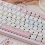 Dreamy pink celestial star keycaps showcasing intricate whimsical astronomical patterns from multiple artistic angles, enhancing a personalized keyboard.