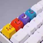 Multiple angles of vibrant, handcrafted resin Pokemon artisan keycaps featuring detailed Bulbasaur and Charmander designs for mechanical keyboards.