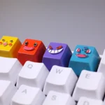 A collection of vibrant handcrafted resin Pokemon artisan keycaps, showcasing detailed miniature Bulbasaur and Charmander from various angles, perfect for fans.