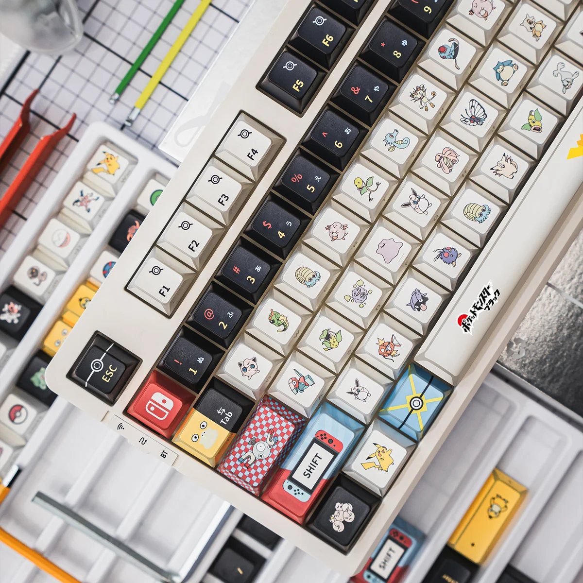 A collection of Pokemon PBT keycaps set from various angles, showcasing the modern geometric art and stunning backlit refraction for artistic touch.
