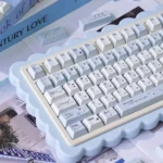 Discover the delightful details of the Whimsical Blue Rain PBT Keycaps set, with adorable cartoon characters visible from different angles.