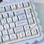 Close-up of the adorable Whimsical Blue Rain PBT keycaps set, showcasing their vibrant cartoon characters and playful blue design from a unique angle.