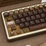 Unique Programmer Coffee PBT Dye-Sub Keycap Set displayed from various angles, revealing cozy coffee shop and abstract coding motifs for a warm dev desk.
