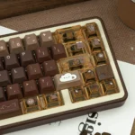 Angled view of the unique Programmer Coffee PBT Dye-Sub Keycap Set, showcasing artistic coffee and coding motifs on PBT keycaps for a cozy dev desk.