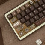 Detailed angled view of the unique Programmer Coffee PBT keycaps, emphasizing the rich dye-sub colors and artistic coffee-inspired designs.
